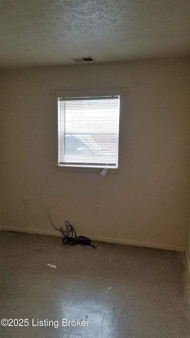 spare room featuring a textured ceiling