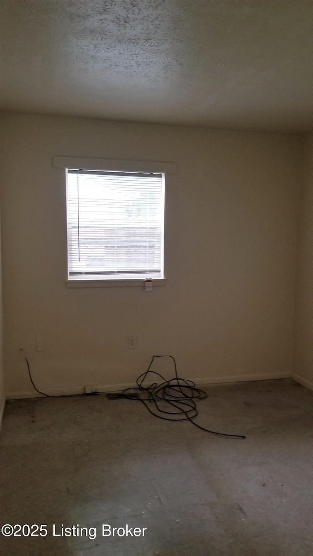 empty room with a textured ceiling