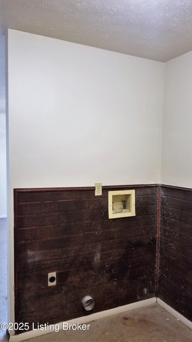 clothes washing area featuring washer hookup, electric dryer hookup, and a textured ceiling