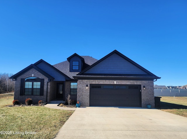 view of front of house with a garage and a front lawn