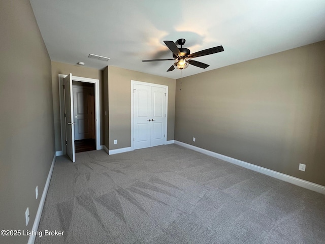 unfurnished bedroom featuring ceiling fan, light carpet, and a closet