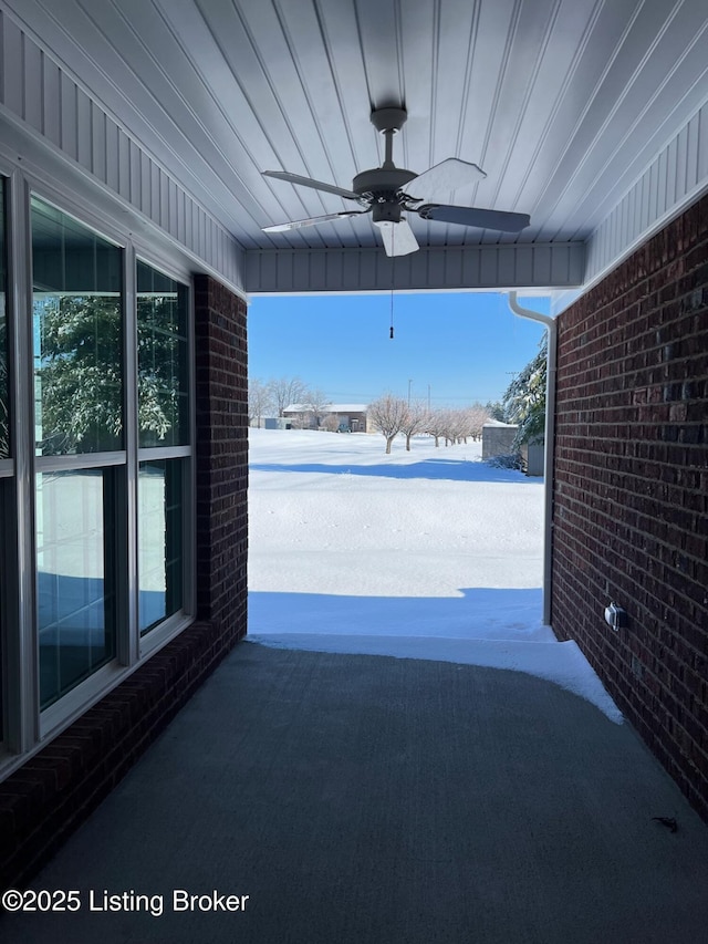 snow covered patio featuring ceiling fan