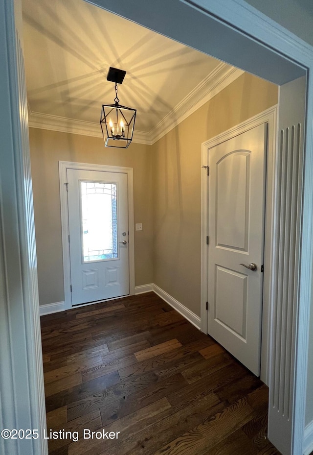 doorway to outside featuring dark hardwood / wood-style floors, ornamental molding, and a chandelier