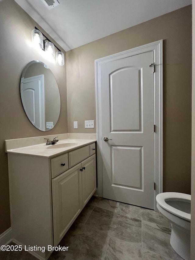 bathroom featuring vanity and toilet