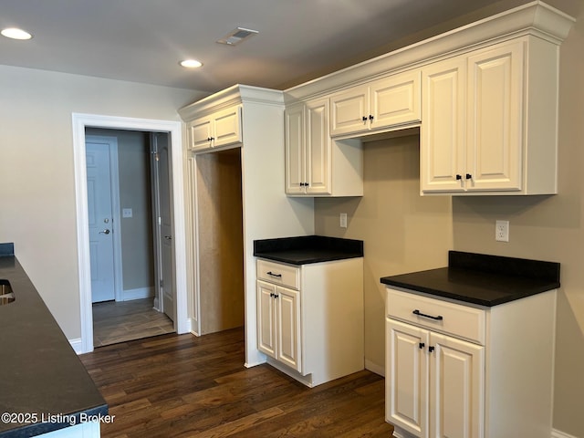 kitchen with dark hardwood / wood-style floors and white cabinetry