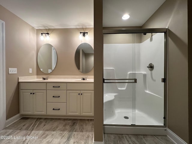 bathroom featuring vanity and an enclosed shower