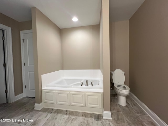 bathroom featuring a bathing tub and toilet