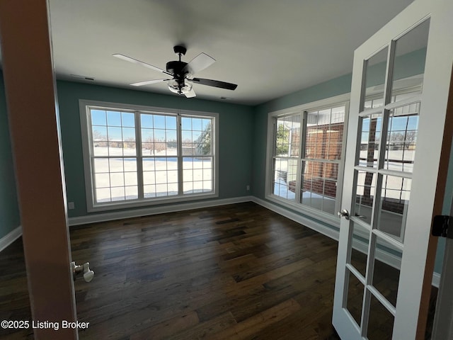 unfurnished room featuring ceiling fan and dark wood-type flooring