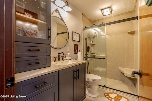 bathroom featuring vanity, crown molding, toilet, a textured ceiling, and an enclosed shower