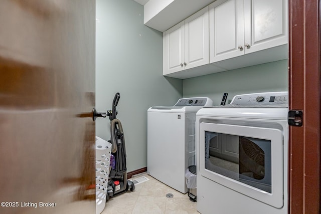 washroom with cabinets, separate washer and dryer, and light tile patterned floors