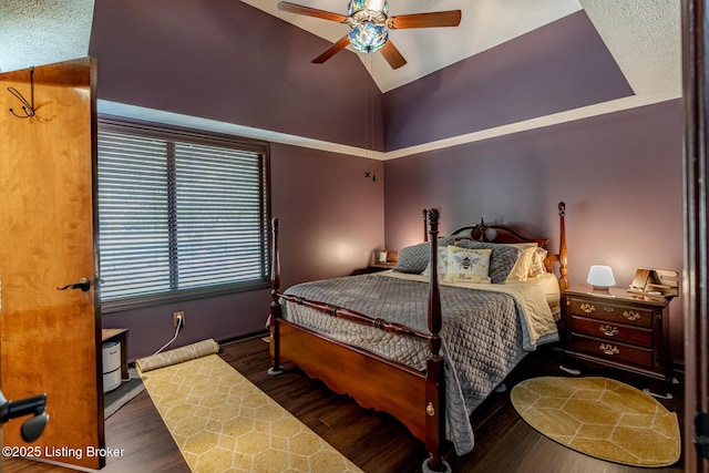 bedroom with ceiling fan, dark hardwood / wood-style flooring, and high vaulted ceiling