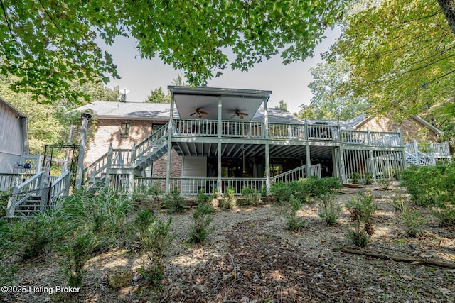 rear view of property with ceiling fan and a deck