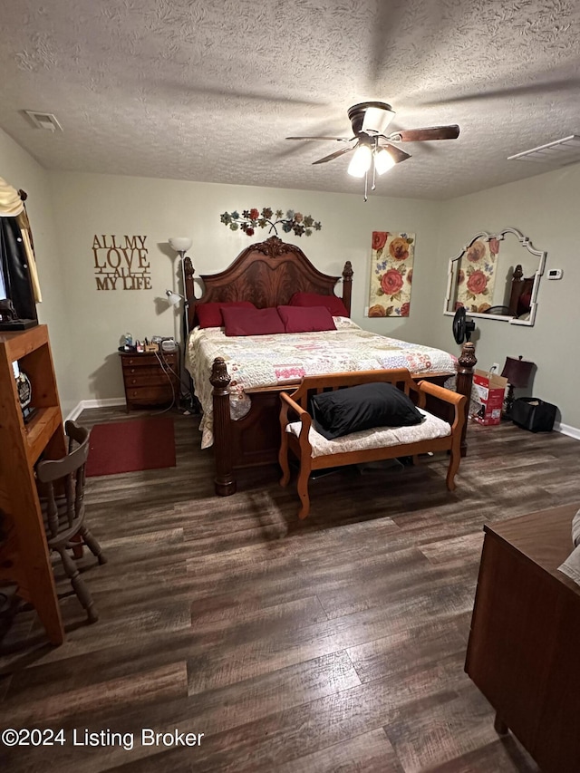 bedroom featuring ceiling fan, dark hardwood / wood-style flooring, and a textured ceiling