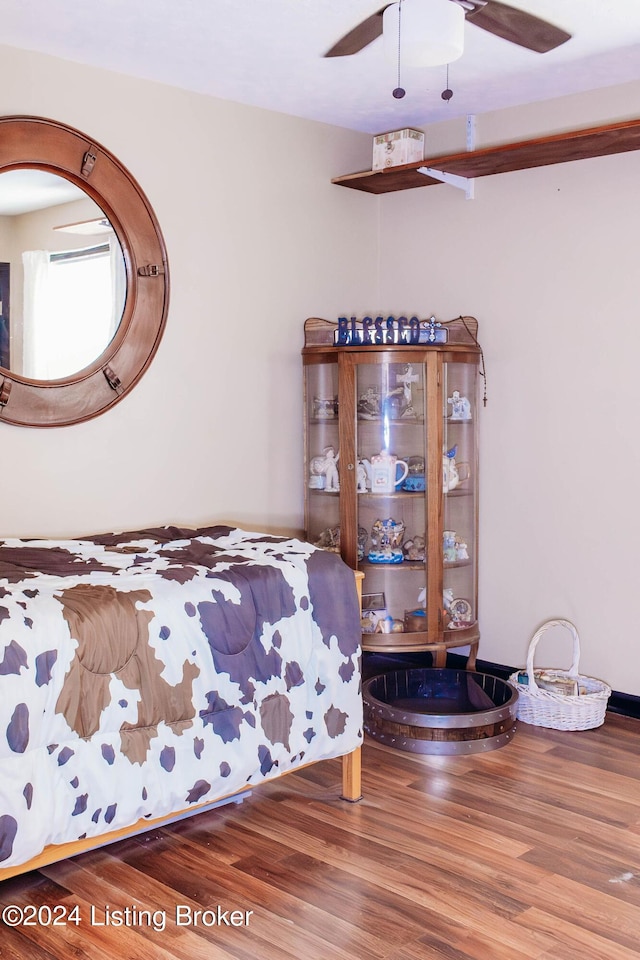 bedroom with ceiling fan and wood-type flooring