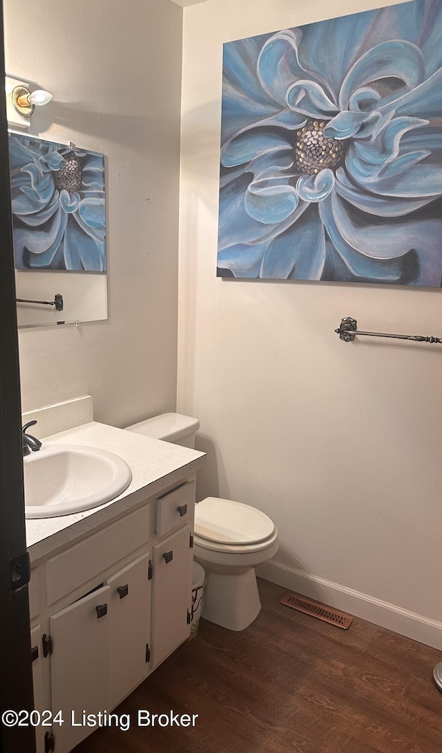 bathroom featuring hardwood / wood-style floors, vanity, and toilet