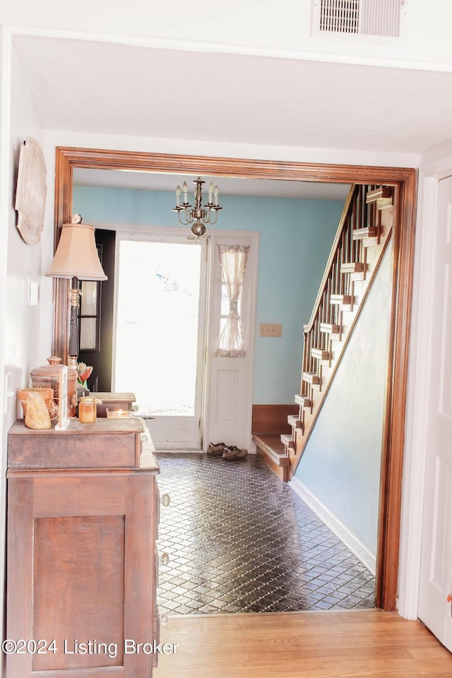 entryway with a notable chandelier