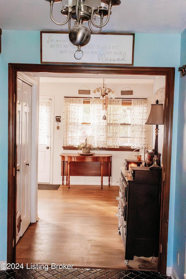 interior space with wood-type flooring and a notable chandelier