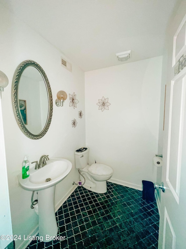 bathroom featuring tile patterned floors and toilet