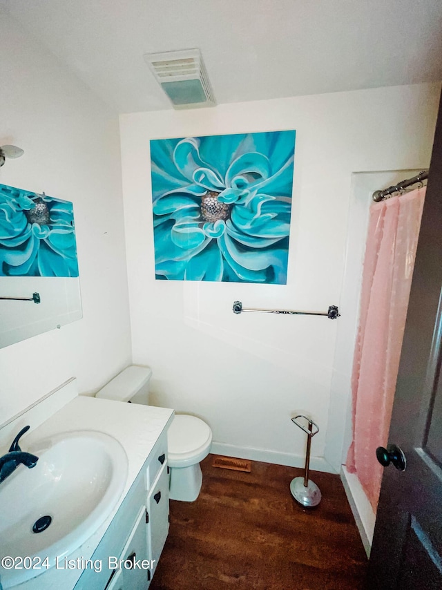 bathroom featuring hardwood / wood-style floors, vanity, and toilet