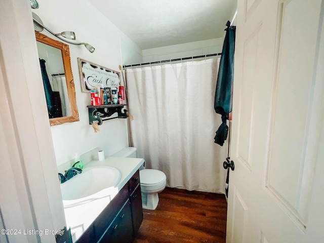 bathroom featuring a shower with curtain, vanity, wood-type flooring, and toilet