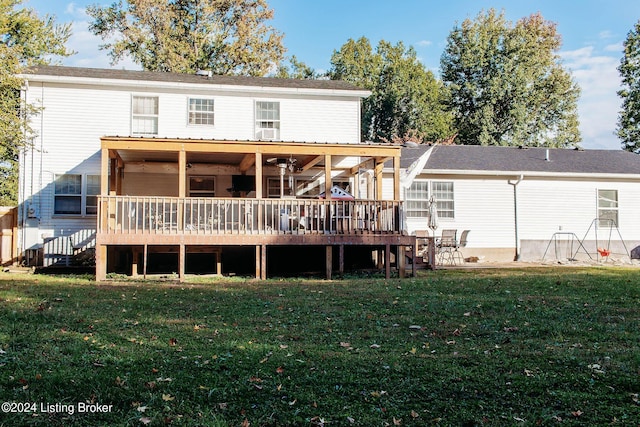 rear view of property with a lawn and a deck