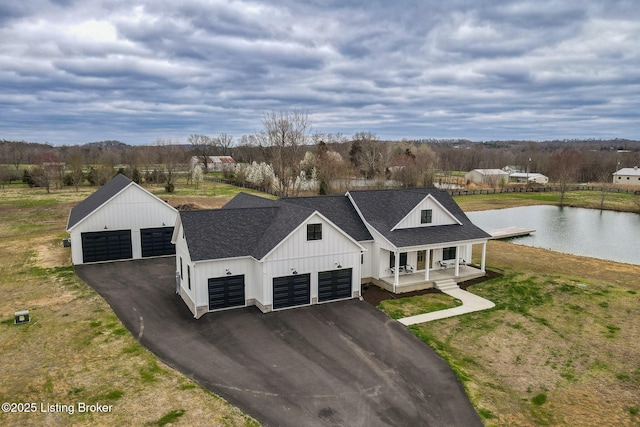 modern inspired farmhouse with a front lawn, a porch, and a garage