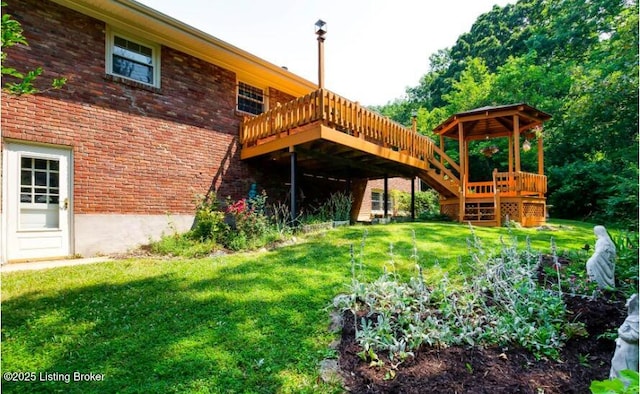 exterior space featuring a lawn and a deck