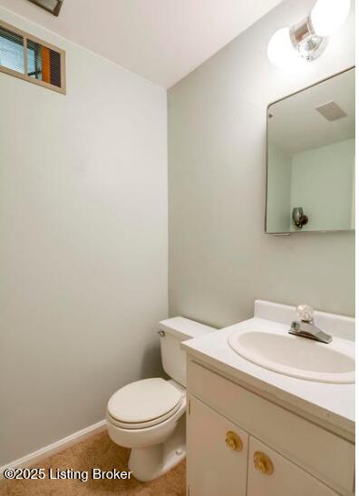 bathroom featuring vanity and toilet