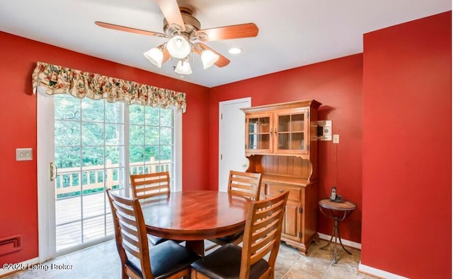 tiled dining space with ceiling fan