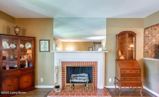 living room featuring hardwood / wood-style floors and a brick fireplace