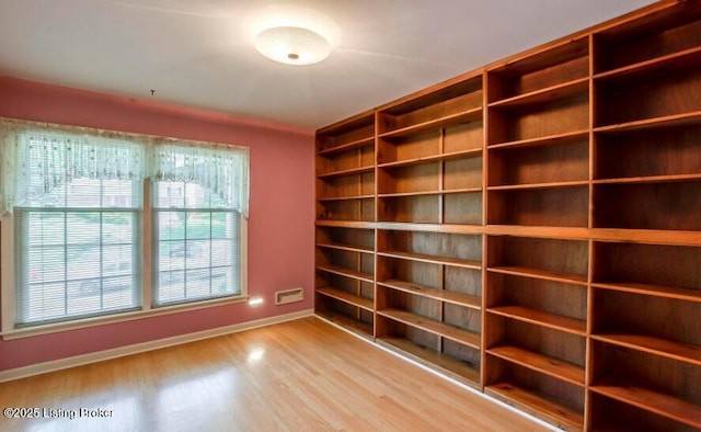 empty room with light hardwood / wood-style flooring