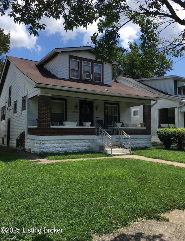 view of front of property with a front yard, a porch, and cooling unit