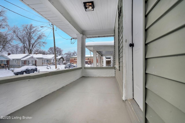 view of snow covered back of property