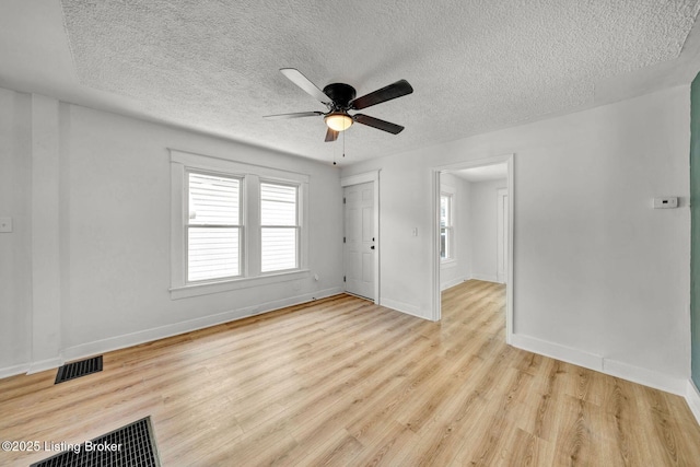 unfurnished room with light wood-type flooring, a textured ceiling, and ceiling fan