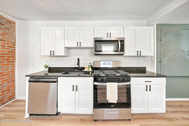 kitchen featuring white cabinetry, sink, and stainless steel appliances