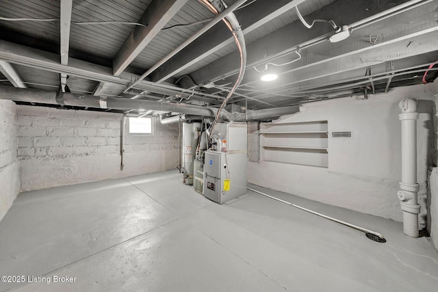 basement featuring heating unit and water heater