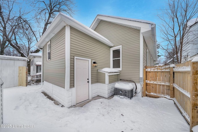 view of snow covered rear of property