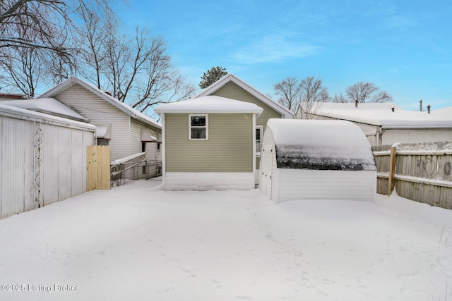 snow covered property with an outdoor structure