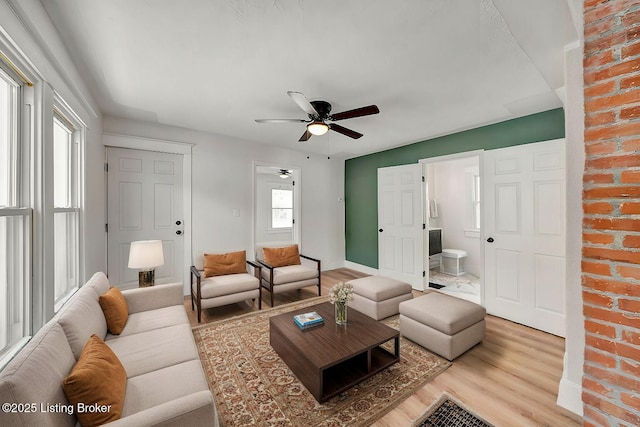 living room featuring hardwood / wood-style floors and ceiling fan