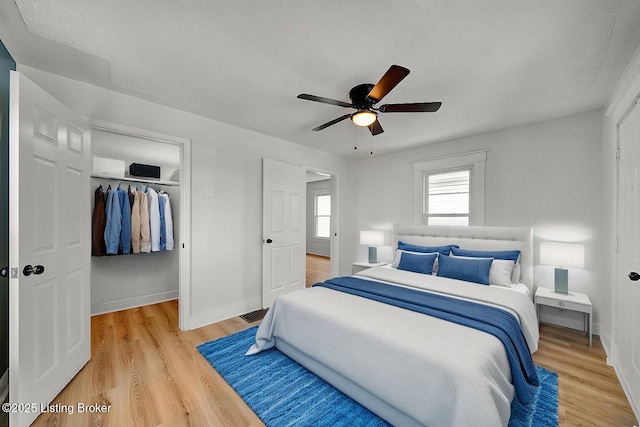 bedroom with wood-type flooring, a closet, and ceiling fan