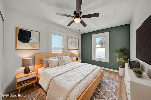 bedroom with hardwood / wood-style floors and ceiling fan