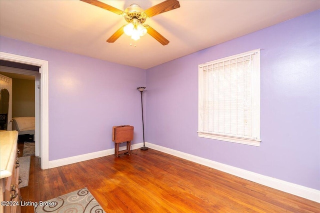 spare room with dark hardwood / wood-style flooring and ceiling fan