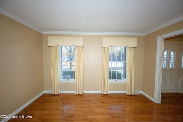 unfurnished room with crown molding and hardwood / wood-style flooring