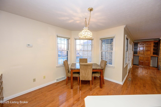 dining area with hardwood / wood-style floors and a notable chandelier