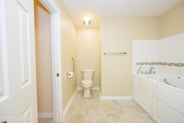 bathroom featuring toilet and a washtub