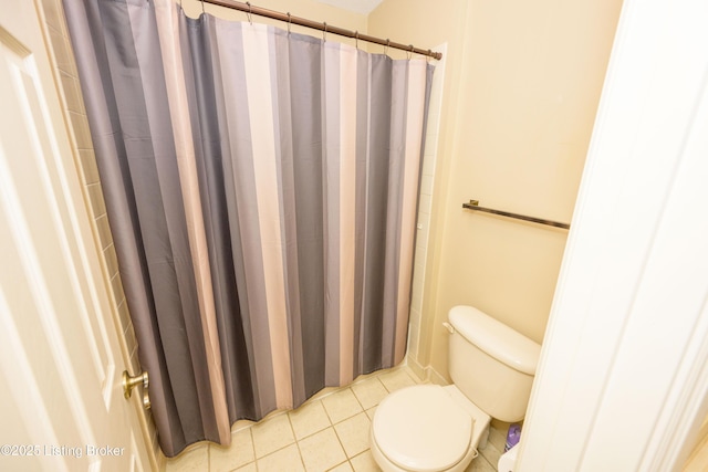 bathroom with toilet, tile patterned flooring, and walk in shower