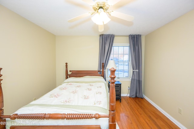 bedroom with ceiling fan and hardwood / wood-style flooring