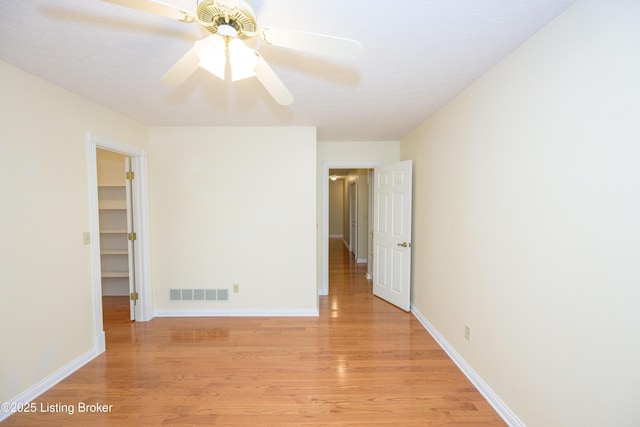 empty room featuring ceiling fan and light hardwood / wood-style flooring