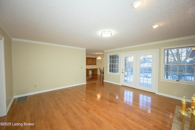 unfurnished living room with light wood-type flooring, crown molding, and a textured ceiling