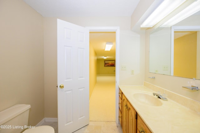 bathroom featuring toilet and vanity